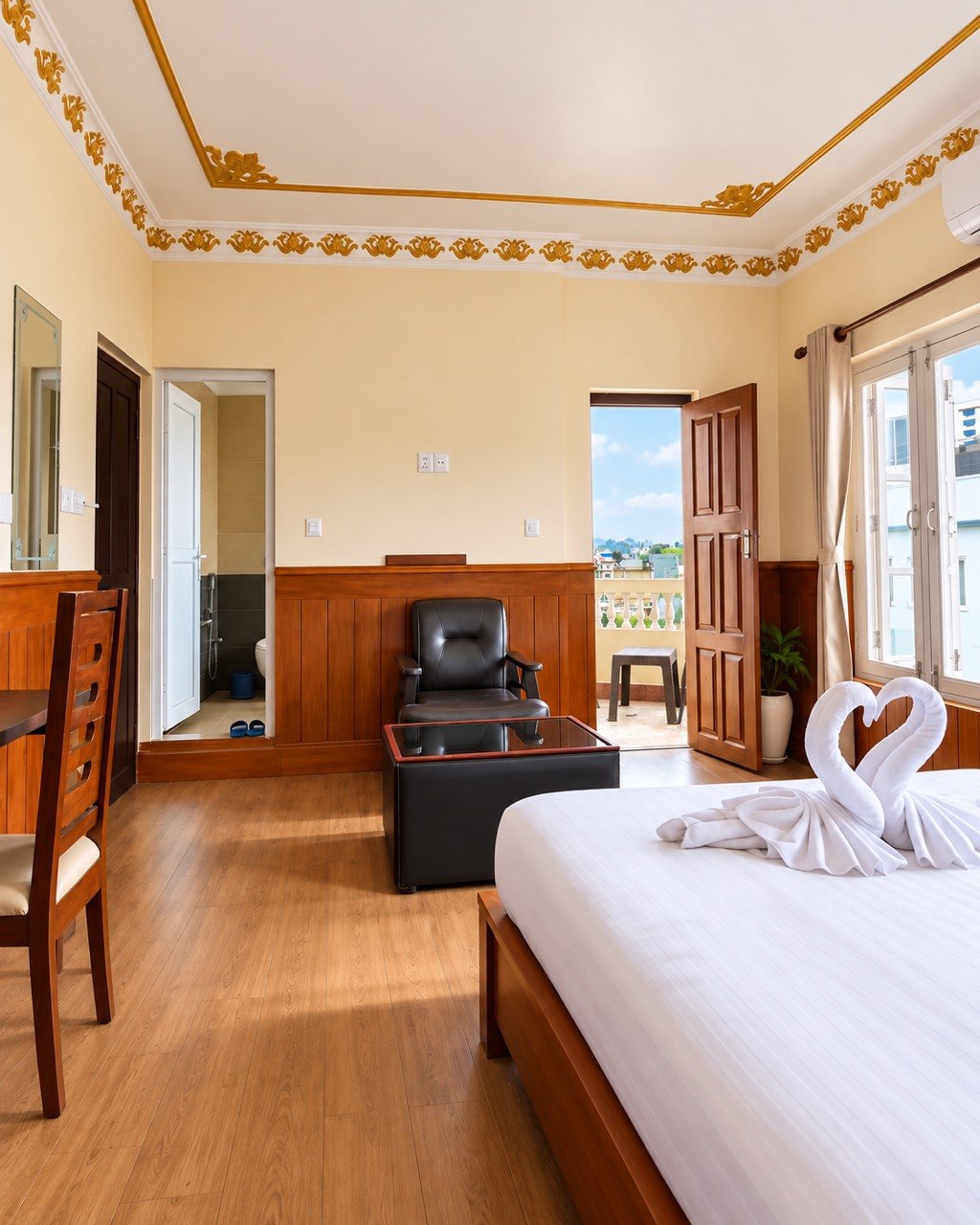 Room with a private balcony and a gilded ceiling border